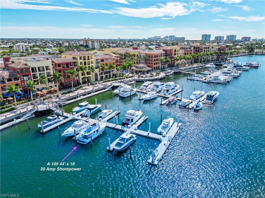 View of urban area with a large body of water and numerous boat docks