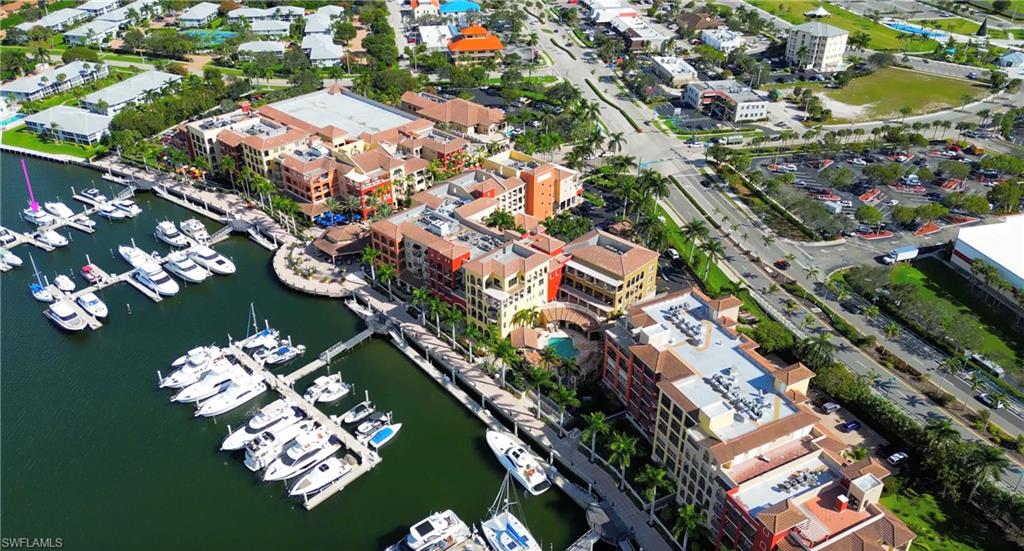 Aerial overview of property's location featuring a marina and a nearby body of water