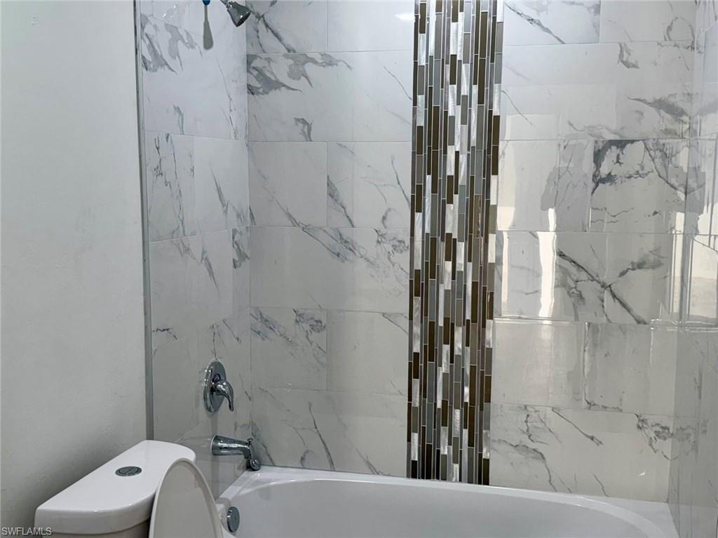 Full bathroom with bathtub / shower combination