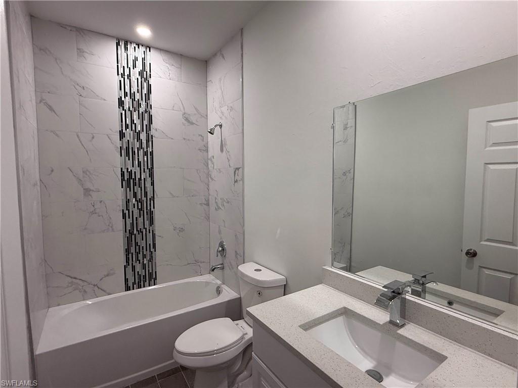 Bathroom featuring  shower combination and vanity