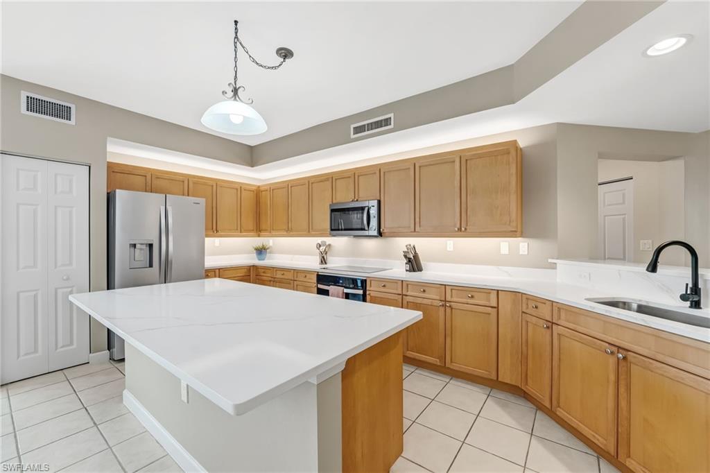 The sellers have recently elevated the kitchen with newly installed quartz countertops and a beautifully redesigned island—perfect for gathering with guests while the chef prepares meals. Enhanced with under- and over-cabinet lighting, brand-new stainless steel appliances, and a fresh, refined repaint throughout, the space exudes a bright, modern sophistication, creating a truly inviting and refreshed culinary environment.