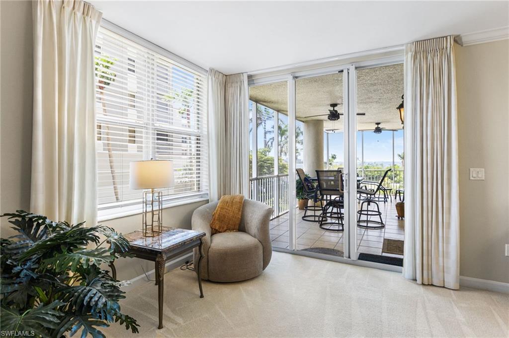 A beautifully appointed sitting area is thoughtfully positioned within the home, offering a serene space to relax and take in the captivating river views—an inviting retreat designed for quiet moments and effortless enjoyment of the waterfront setting.