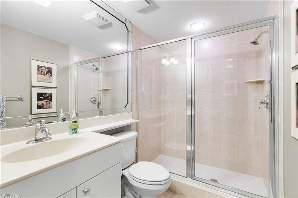 The third full bathroom is elegantly appointed with a walk-in shower finished in floor-to-ceiling porcelain tile and a sleek single vanity, offering a refined and modern aesthetic. Conveniently located just outside the den/third bedroom, it also serves as a sophisticated guest bath, providing both comfort and privacy for visiting guests.