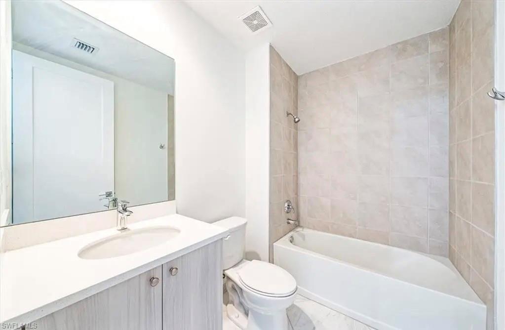 Bathroom featuring vanity and shower / washtub combination