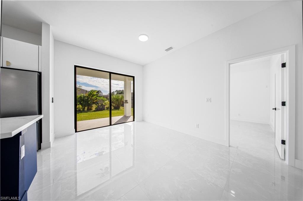 Unfurnished living room with baseboards