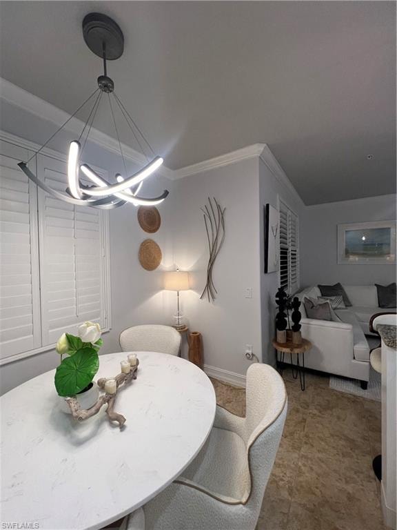 Dining space featuring crown molding and a chandelier