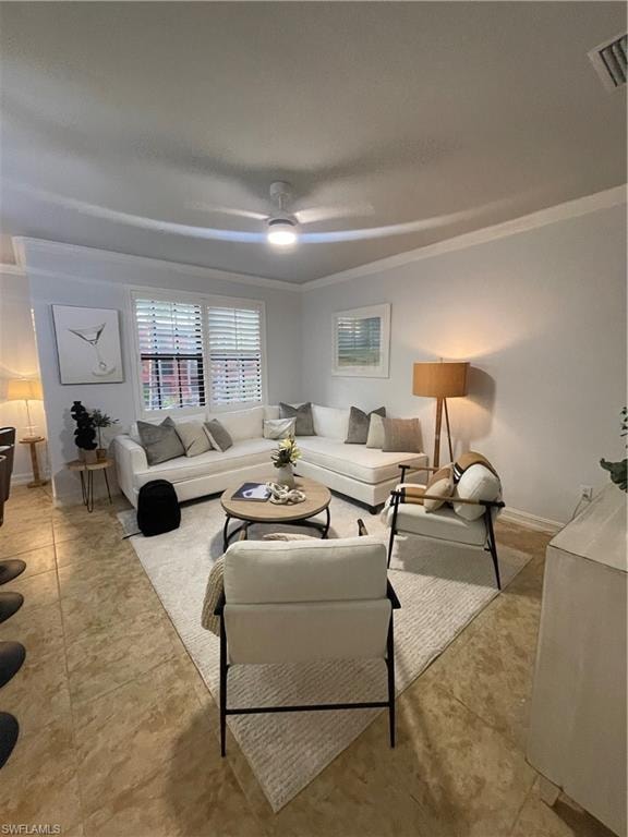 Living room with ornamental molding and a ceiling fan