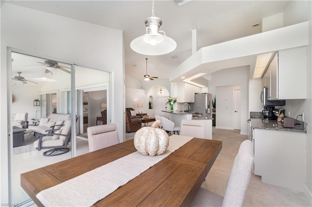 Dining room with a ceiling fan and baseboards