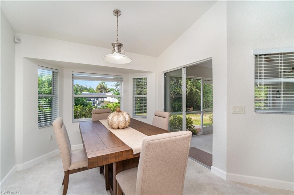 Dining room with vaulted ceiling and plenty of natural light