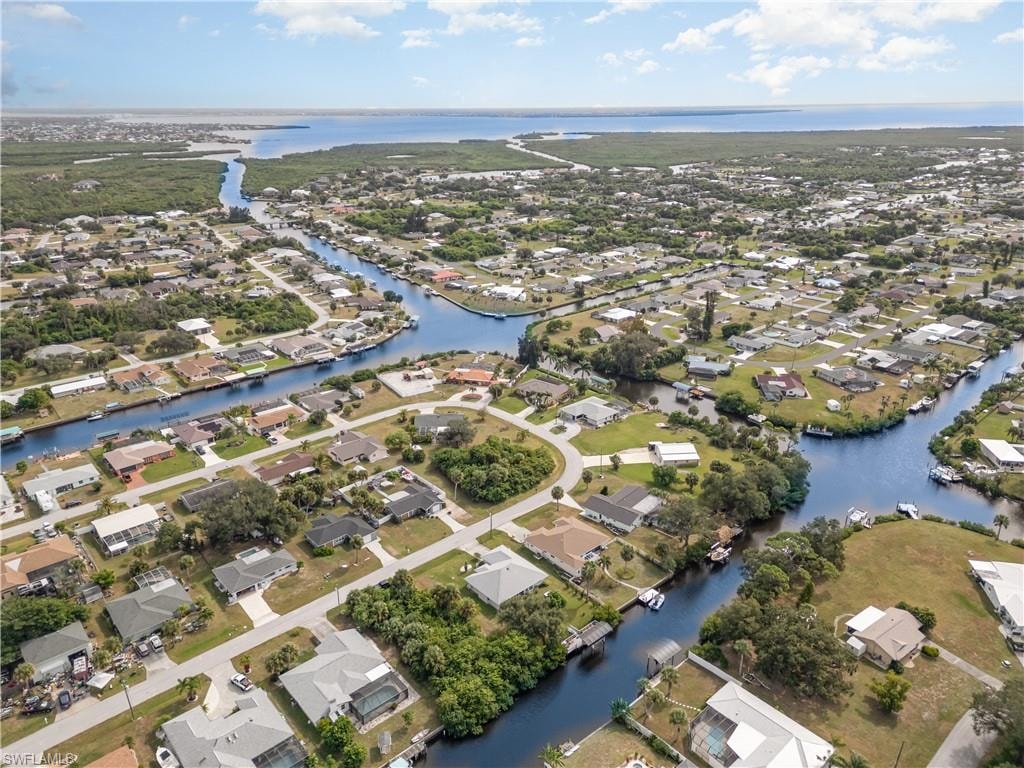 View of property location with nearby suburban area and a nearby body of water