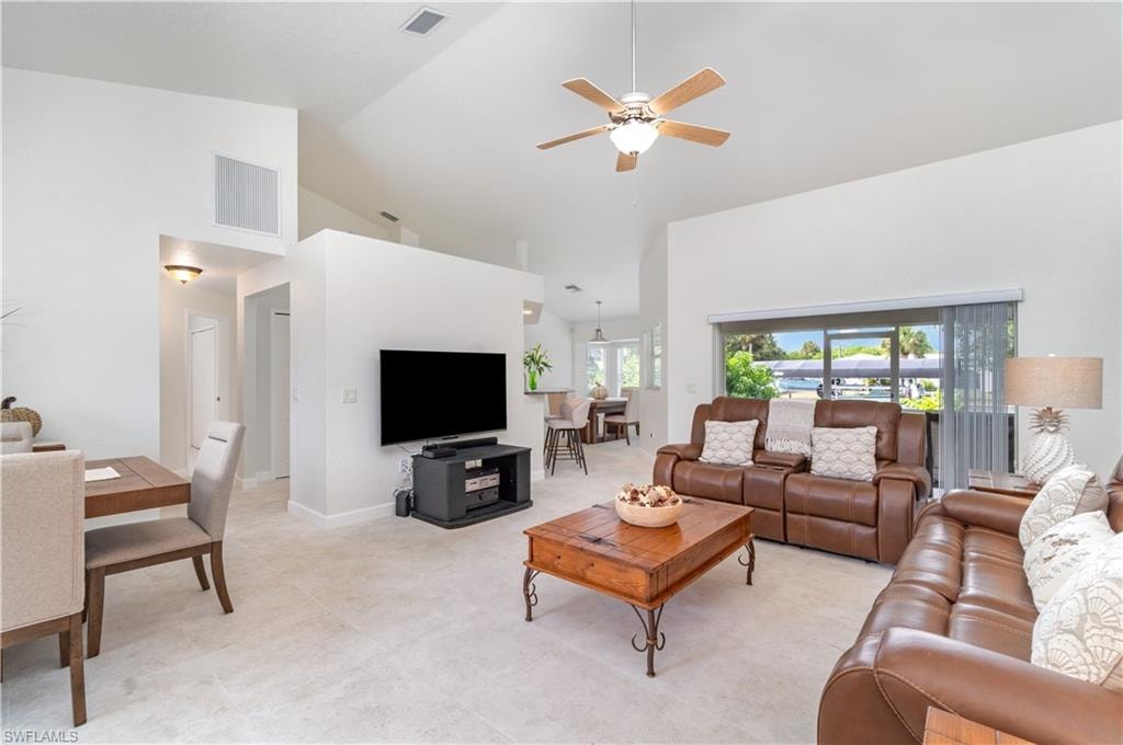Living room with high vaulted ceiling and ceiling fan