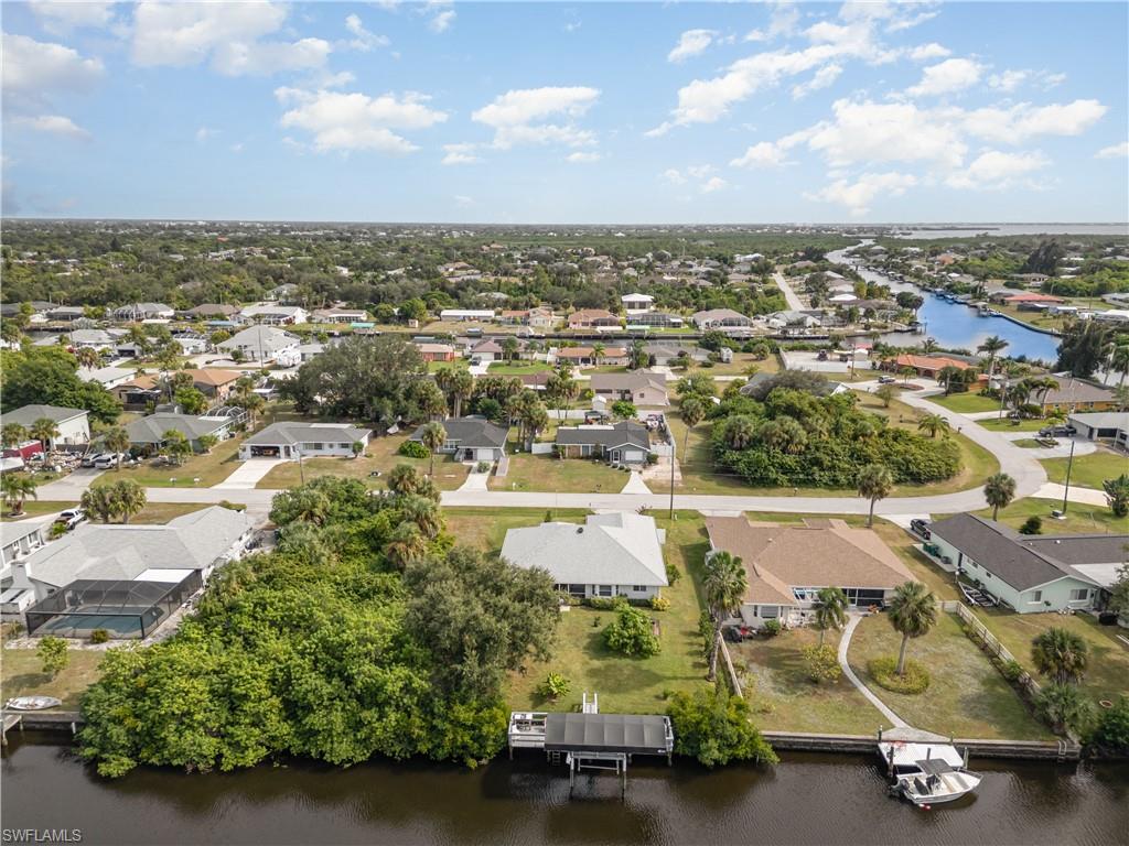 Aerial view of residential area featuring a nearby body of water