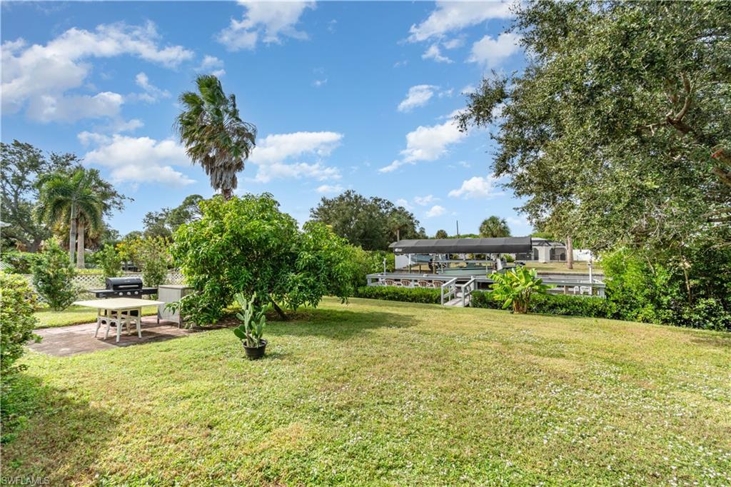 View of green lawn with a patio