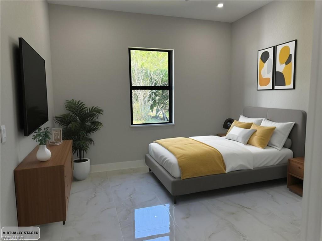 Bedroom with marble finish flooring and recessed lighting