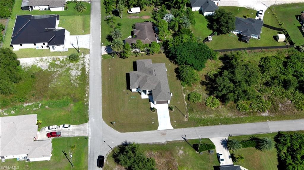Aerial view of property's location with nearby suburban area