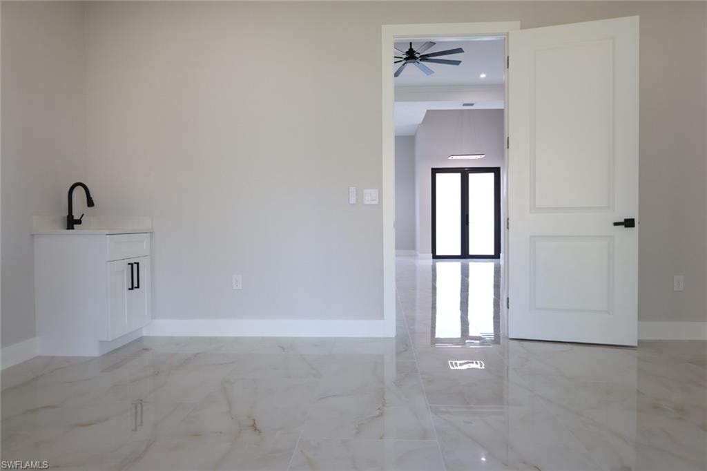 Empty room with light marble finish flooring and recessed lighting