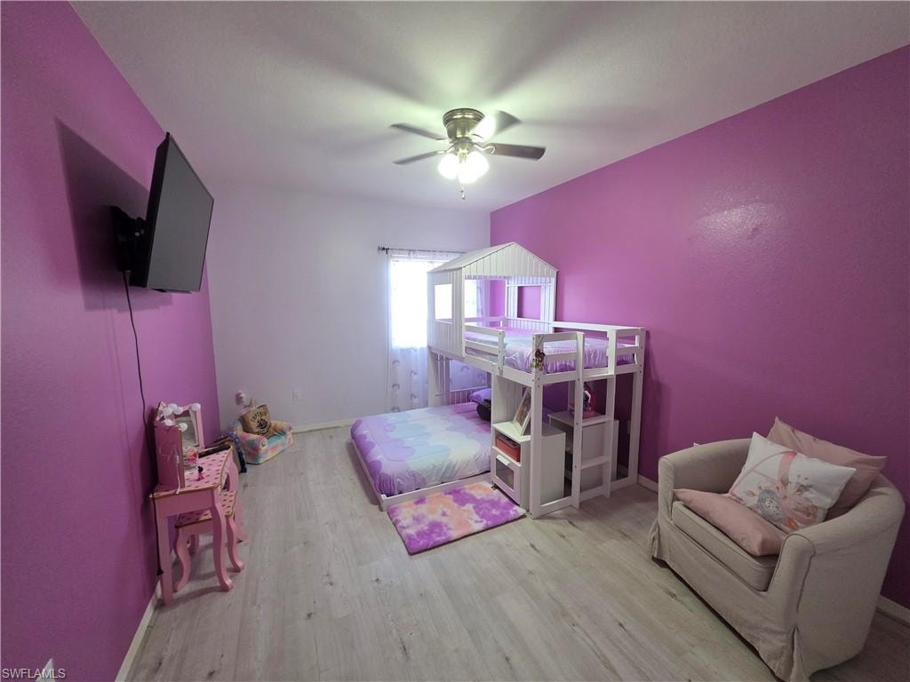 Bedroom featuring light wood-type flooring and a ceiling fan