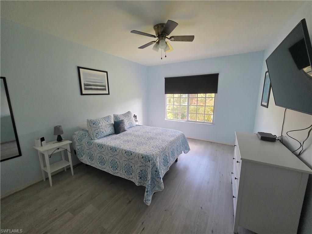 Bedroom with light wood finished floors and ceiling fan