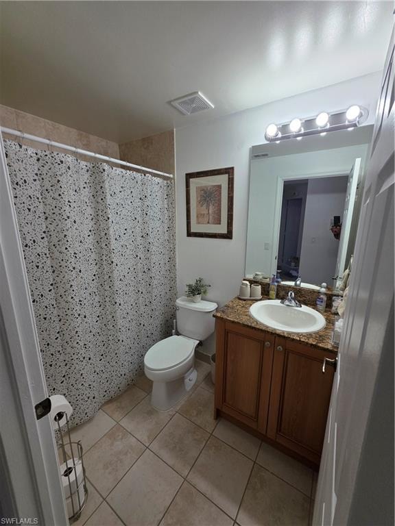 Full bath with a shower with curtain, vanity, and light tile patterned floors