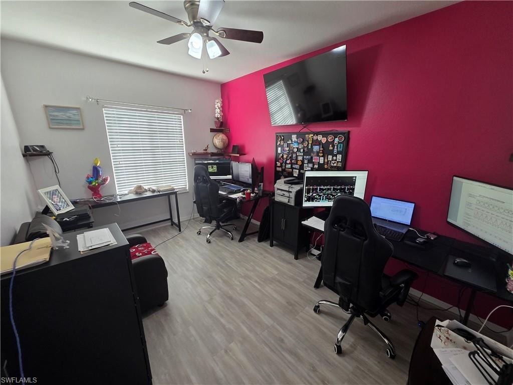 Home office featuring light wood-style floors and a ceiling fan