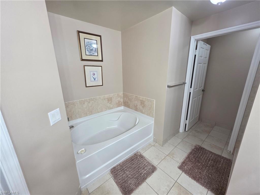 Bathroom featuring a bath and light tile patterned floors