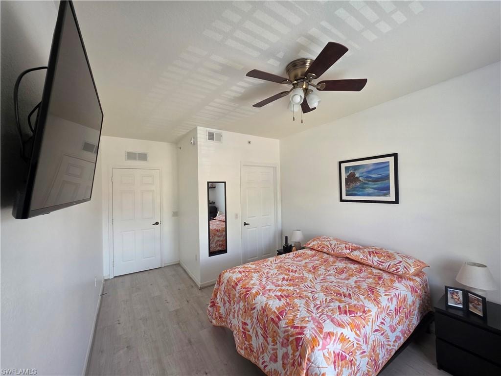 Bedroom with wood finished floors and a ceiling fan