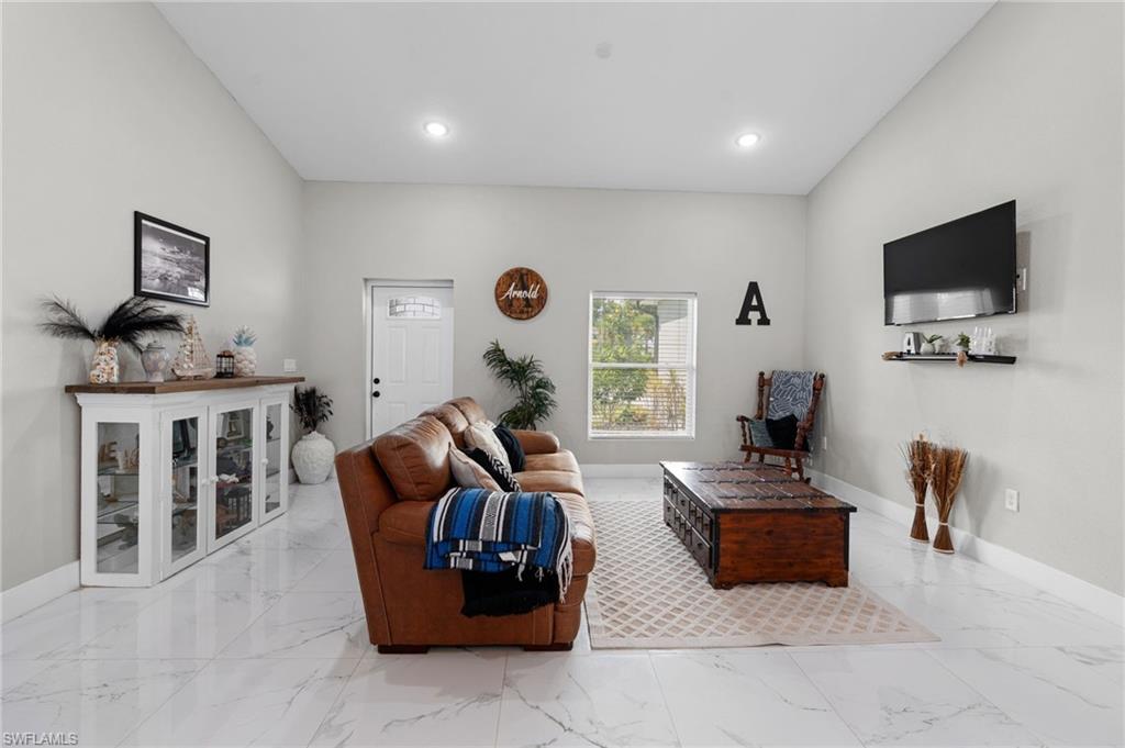 Living room featuring recessed lighting and light marble finish floors