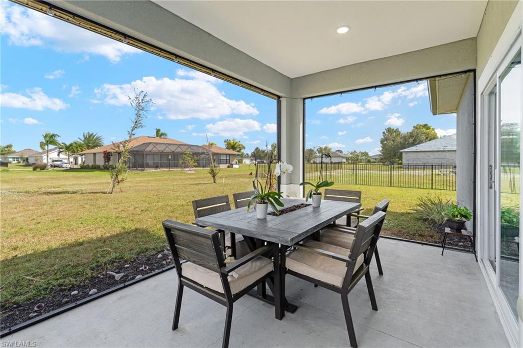 Sunroom featuring a residential view, finished concrete flooring, and recessed lighting