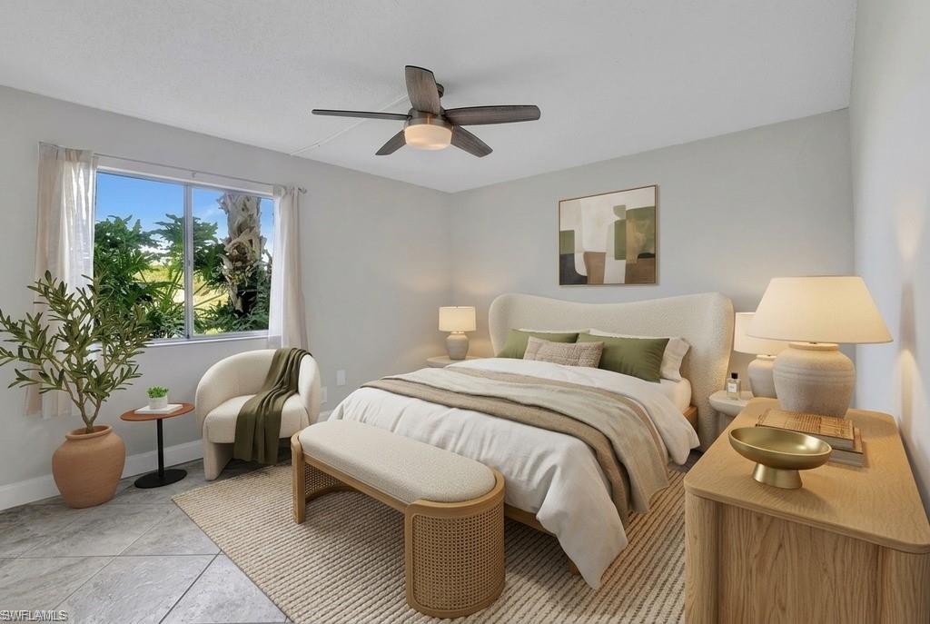 Virtual StagedSpacious room featuring light gray wall paint, a window with outdoor foliage, a ceiling fan with light, and light-toned flooring
