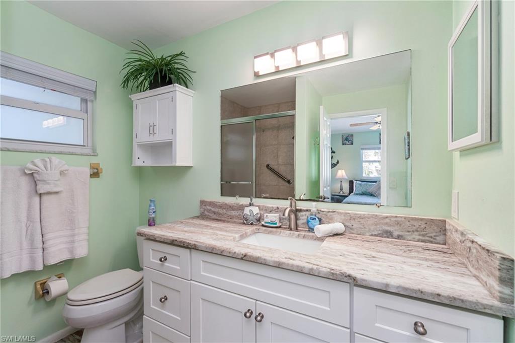 Full bath with ensuite bathroom, vanity, and a shower stall