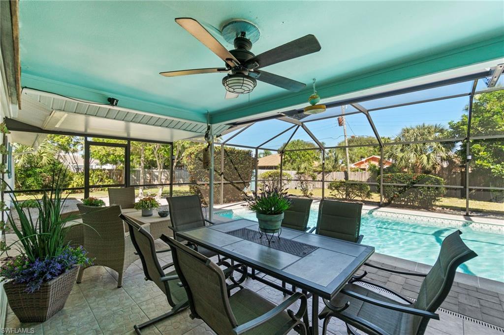 Sunroom featuring a ceiling fan, a patio, and outdoor dining area