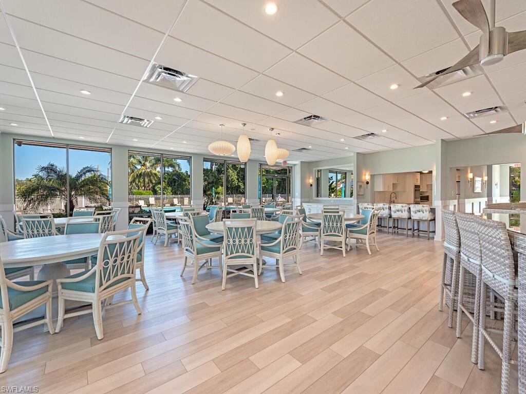 Club House with a drop ceiling, light wood-style floors, and recessed lighting