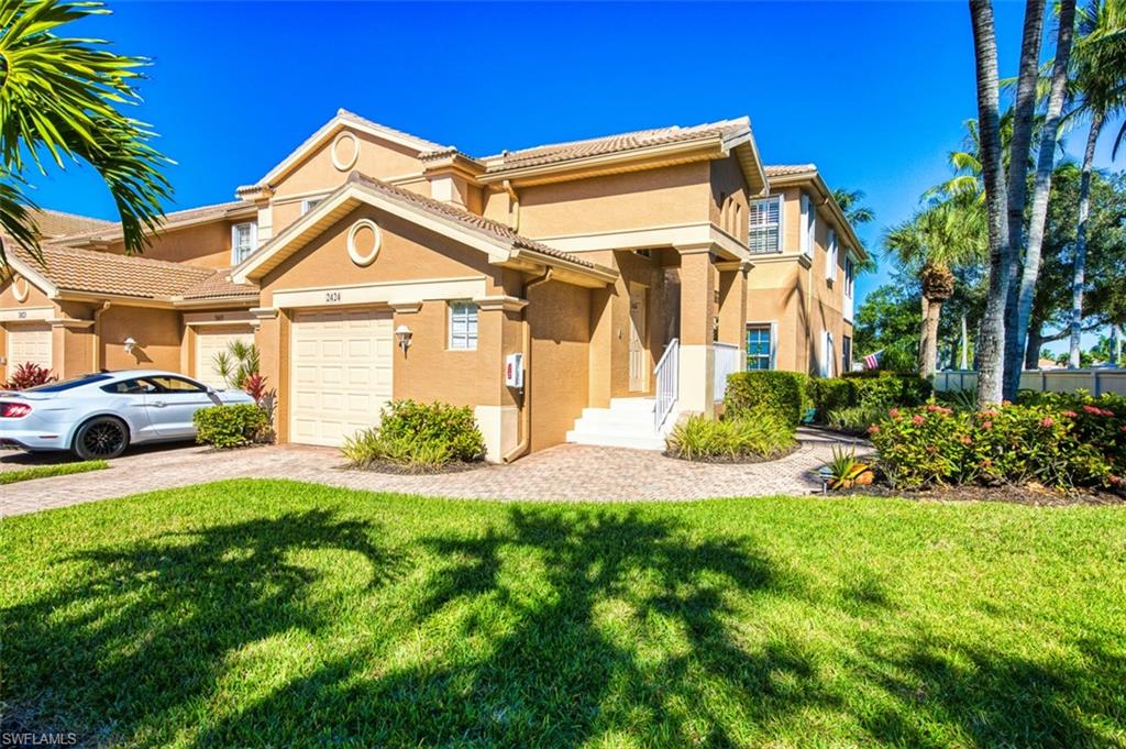 Mediterranean / spanish-style house featuring stucco siding, a front yard, and a tiled roof