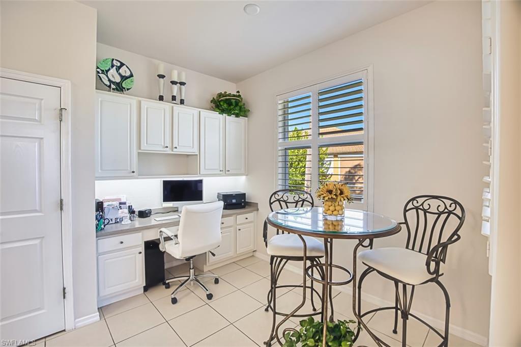 Office space with built in study area and light tile patterned flooring