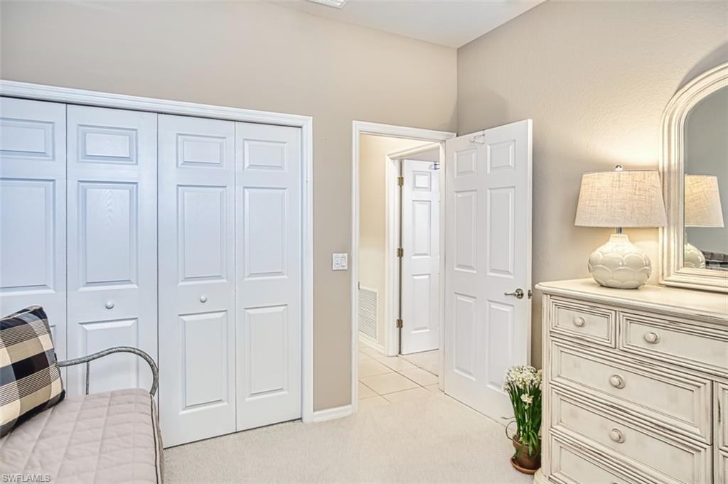 Bedroom featuring light carpet and a closet