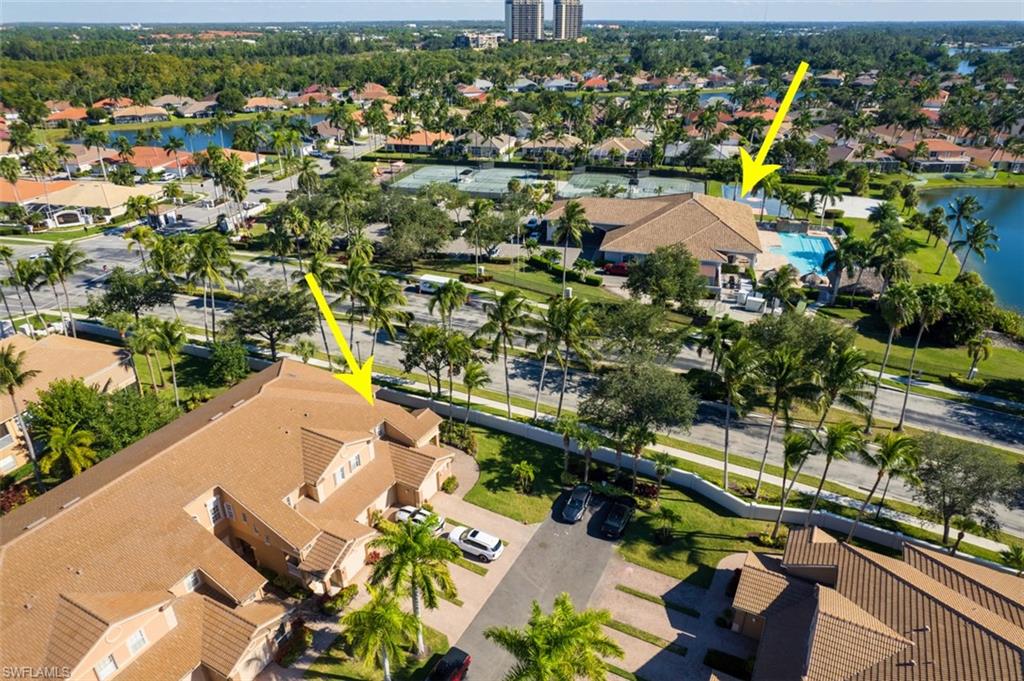 Aerial perspective of suburban area featuring a nearby body of water