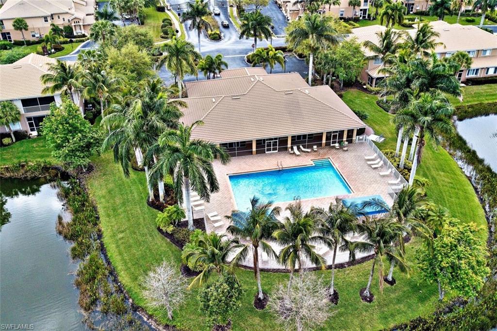 Aerial view of residential area with a pool area and a large body of water
