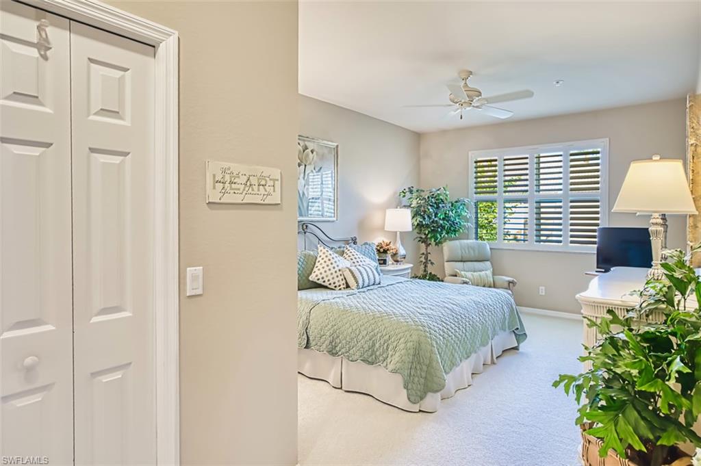 Carpeted bedroom with baseboards and a ceiling fan