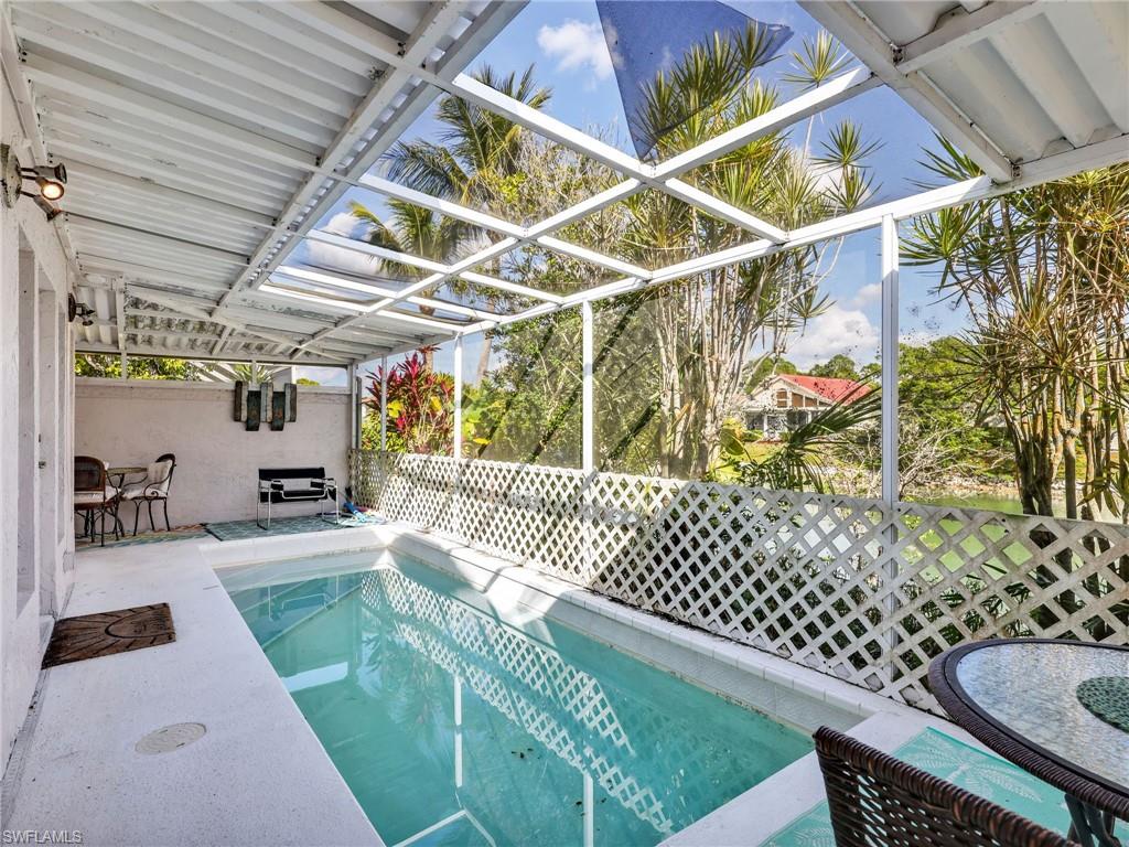 Screened pool enclosure with a partially covered patio.  Latticework has been removed.