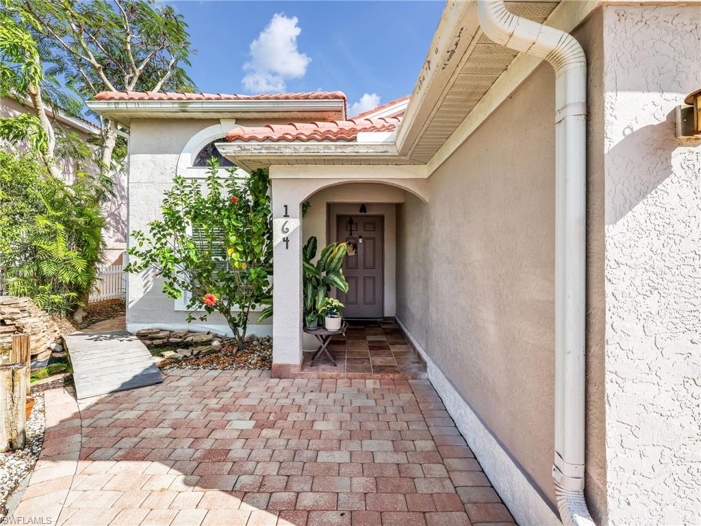 Doorway to property with stucco siding