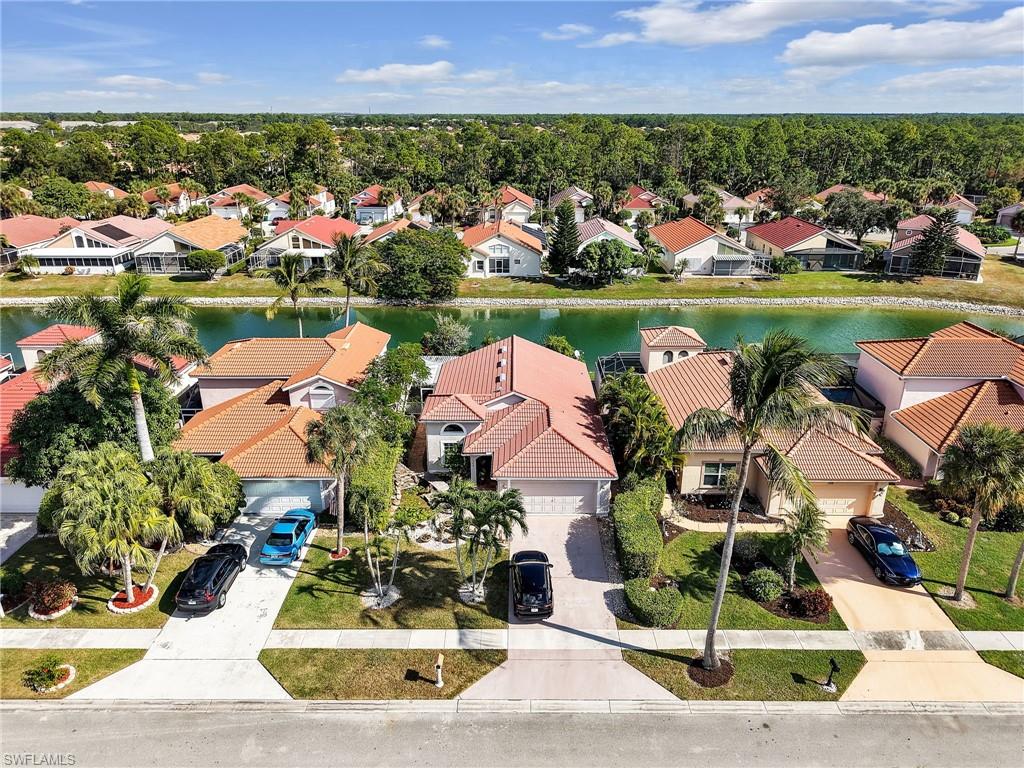 Aerial view of residential area featuring a large body of water