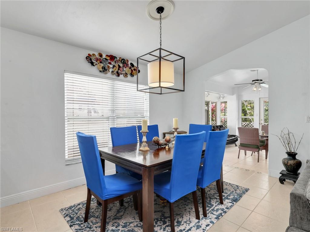 Dining area with a ceiling fan and light tile patterned floors