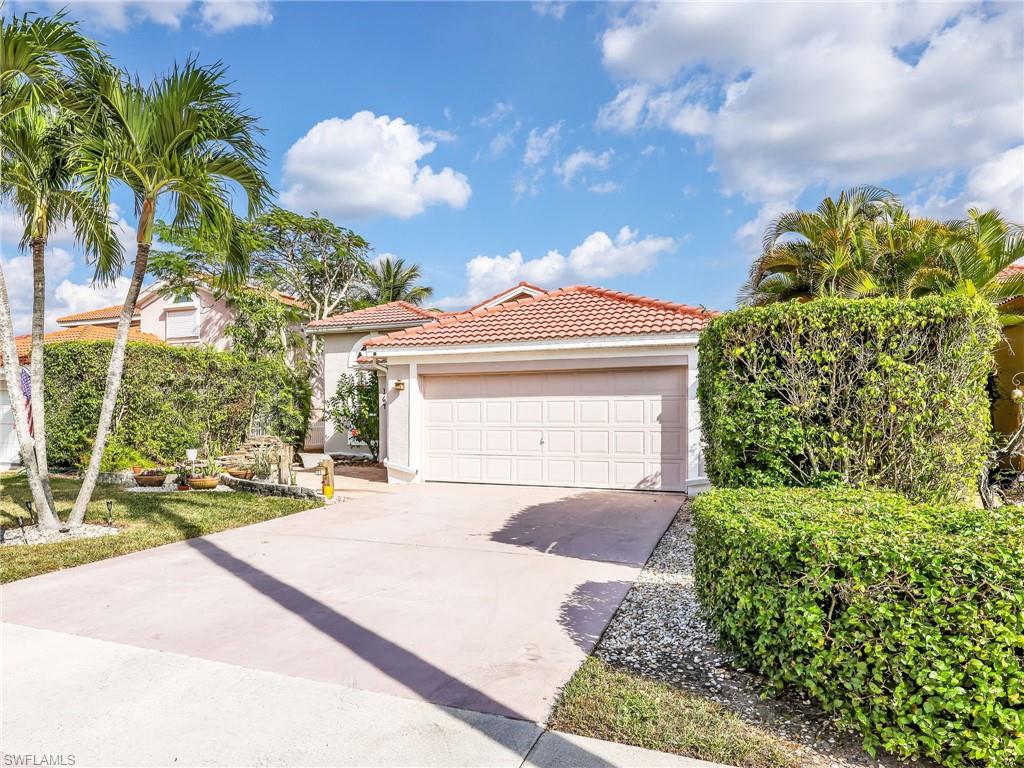 Mediterranean / spanish house featuring stucco siding, concrete driveway, and a tiled roof