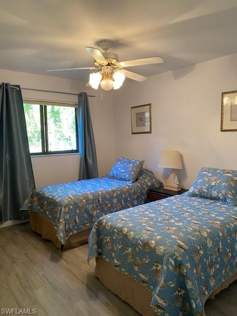 Bedroom with hardwood / wood-style flooring and ceiling fan