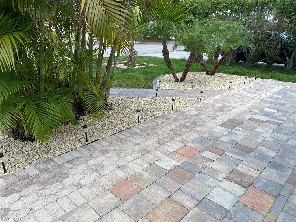 The pathway in front of the house and the greenery.