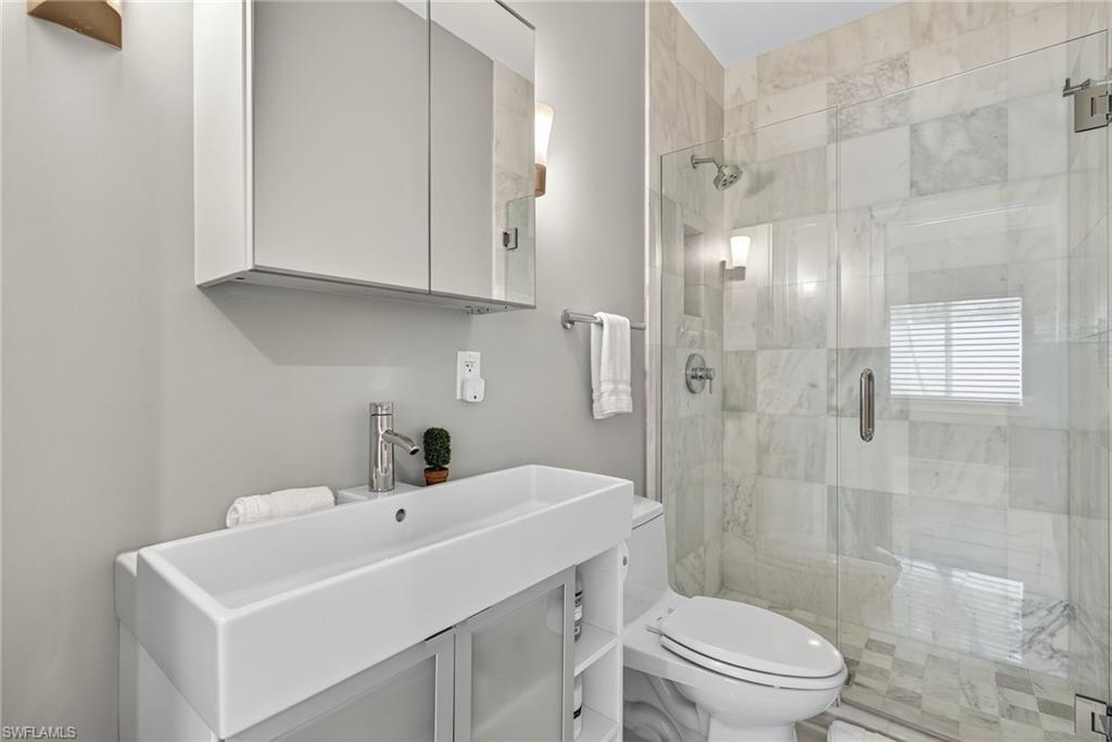 Bathroom with vanity and a stall shower