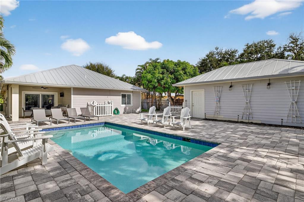 View of swimming pool with a patio area and a ceiling fan