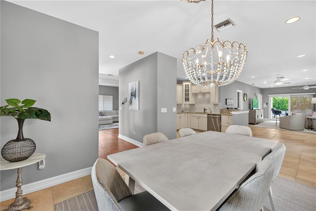 Dining area featuring light tile patterned floors, a chandelier, ceiling fan, and recessed lighting