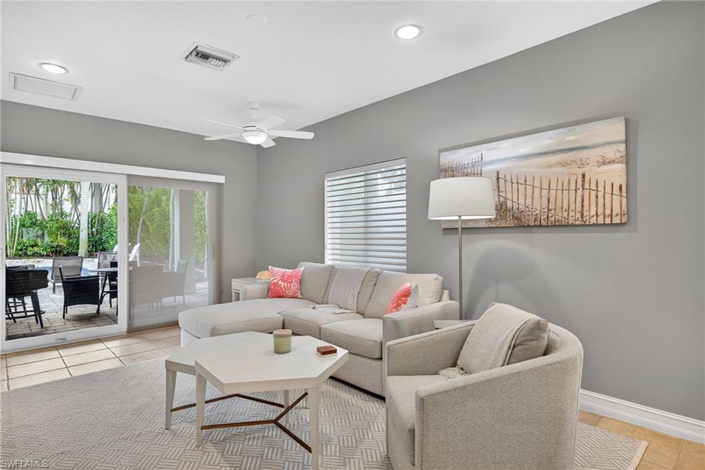 Living area featuring light tile patterned floors, ceiling fan, and recessed lighting