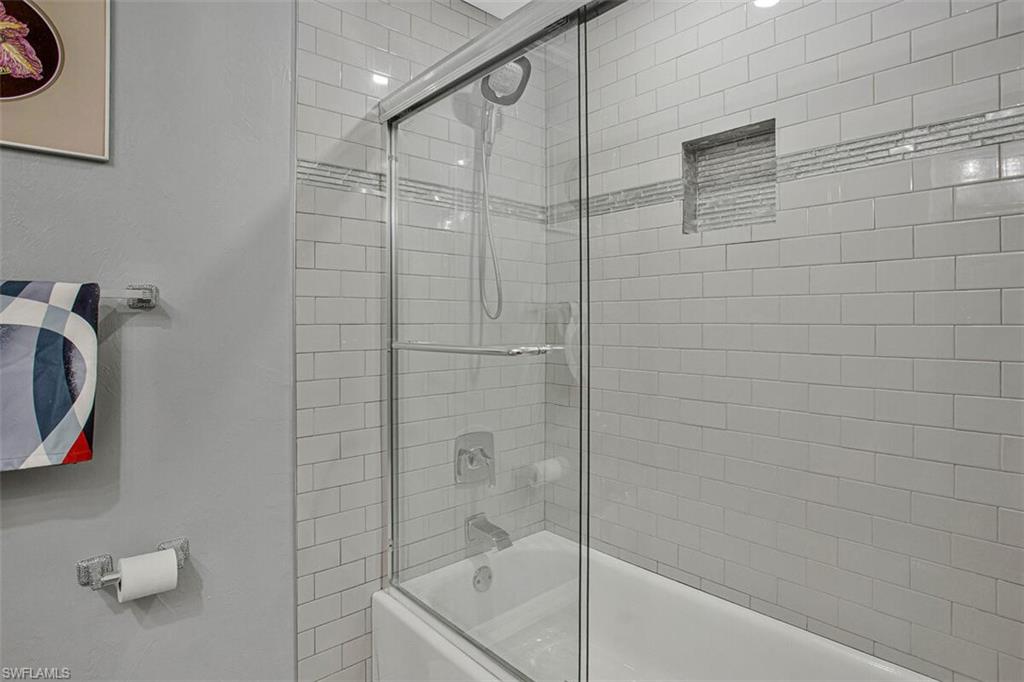Full bath with shower / bath combination with glass door